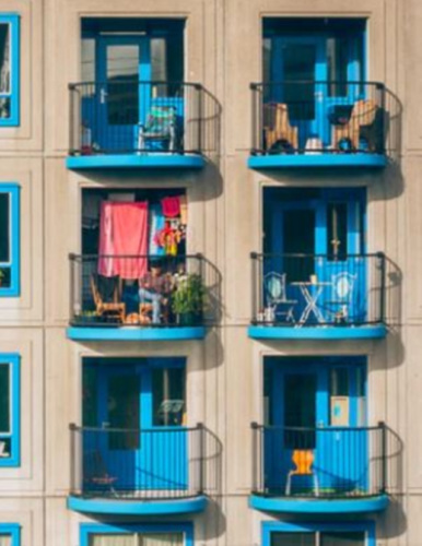 an apartment building with blue terraces