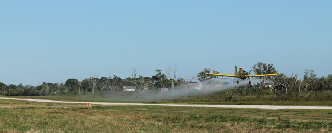 an airplane crop dusting a field