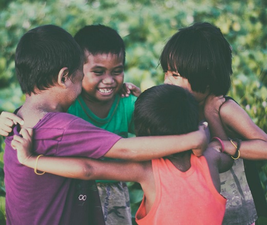 Four children linking arms