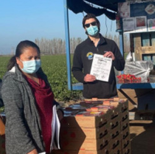 Two people wearing masks at an outdoor vaccine clinic