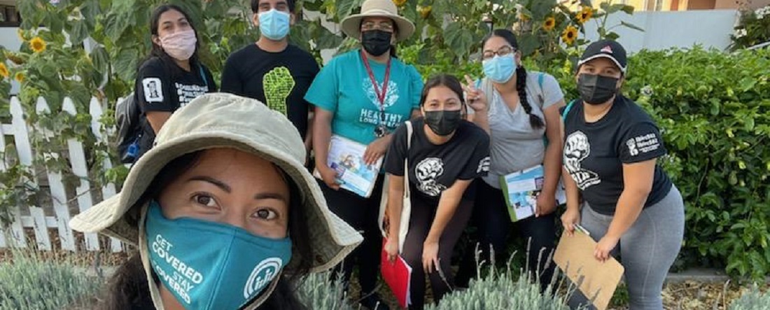 Vaccine canvassers from Long Beach Forward and LB Immigrant Rights wearing masks and looking at camera