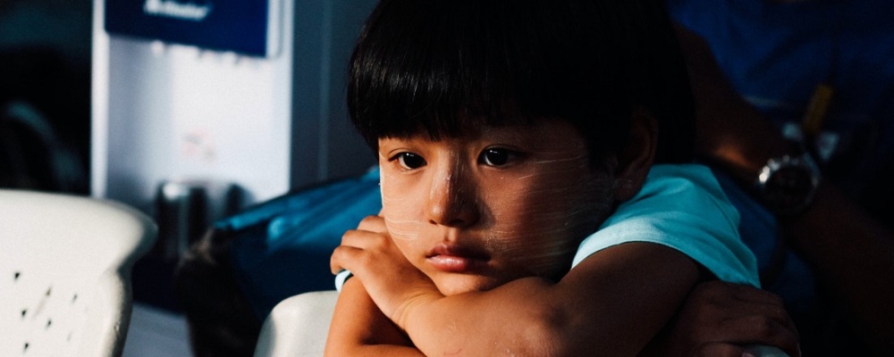 Young girl with arms crossed, looking sad