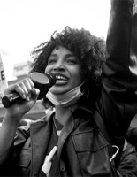woman holding microphone during protest 