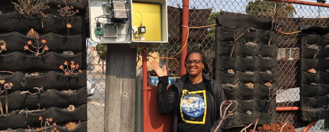 Tiffany Williams, an air-monitor technician, shows one of the devices that are collecting real-time data on air quality in Bayview. 48hills photo