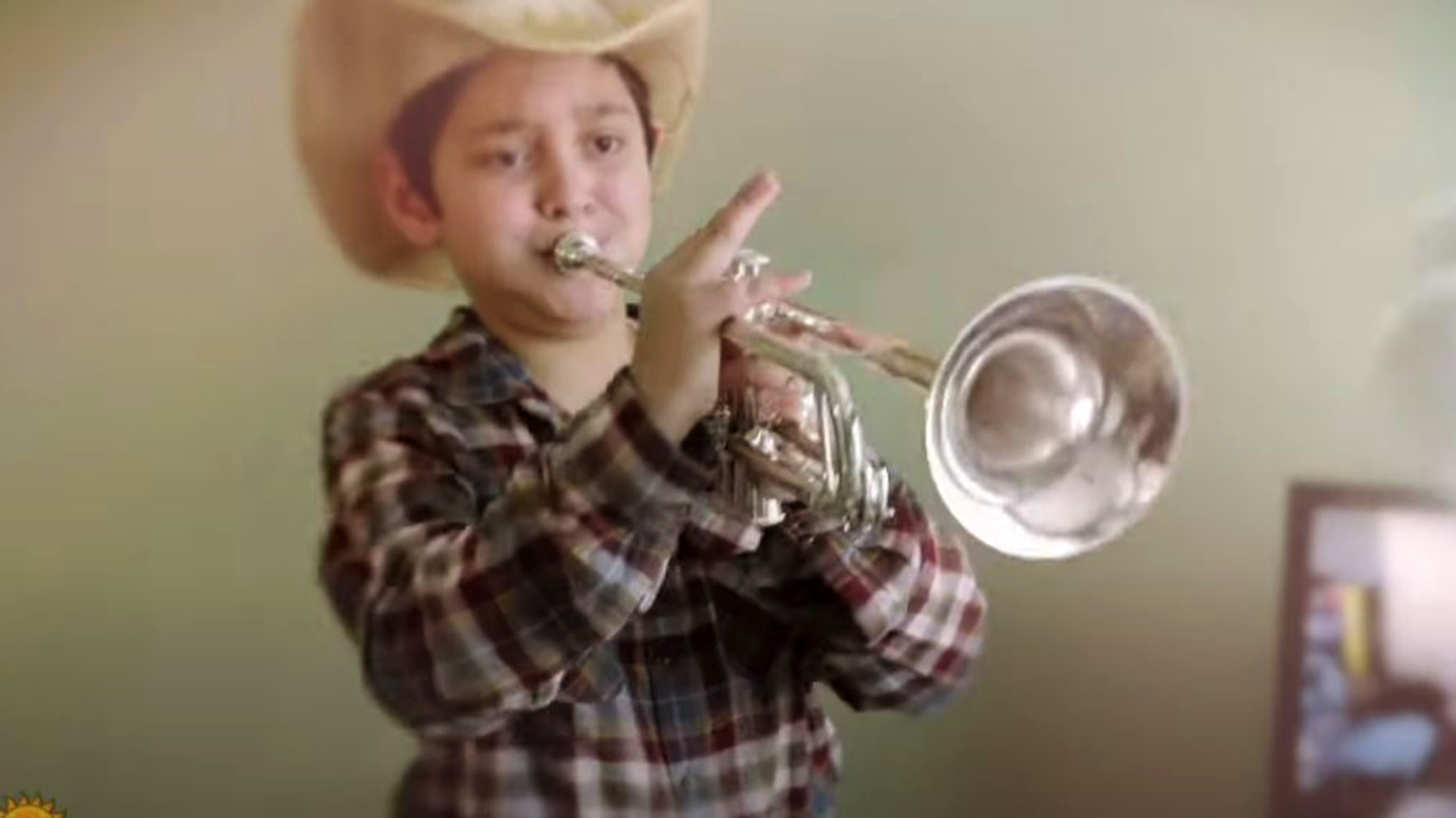 a boy playing a trumpet