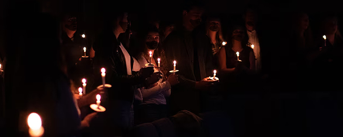 People wearing masks at vigil