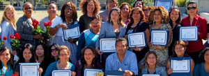 A group of trainees holding up their certificates