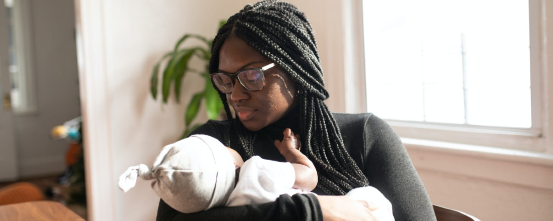 An African-American Mom holding her new baby