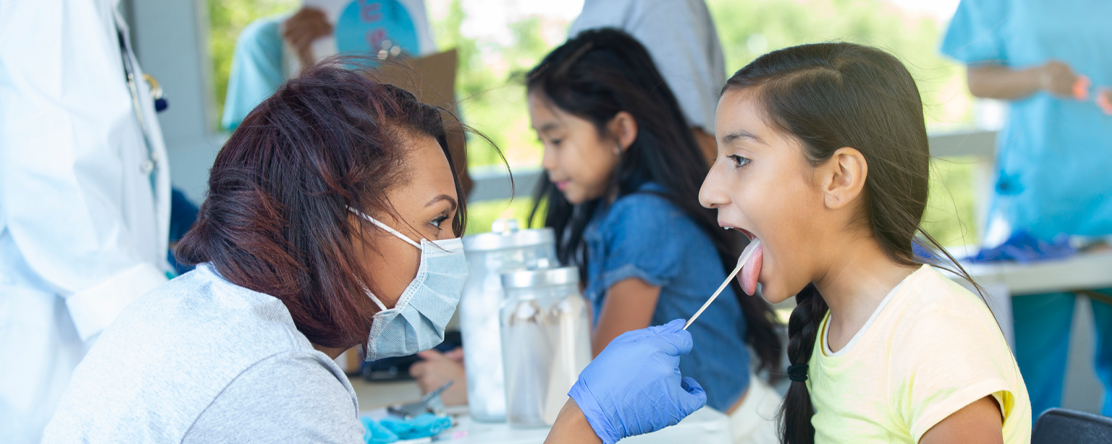 doctor checking child's mouth