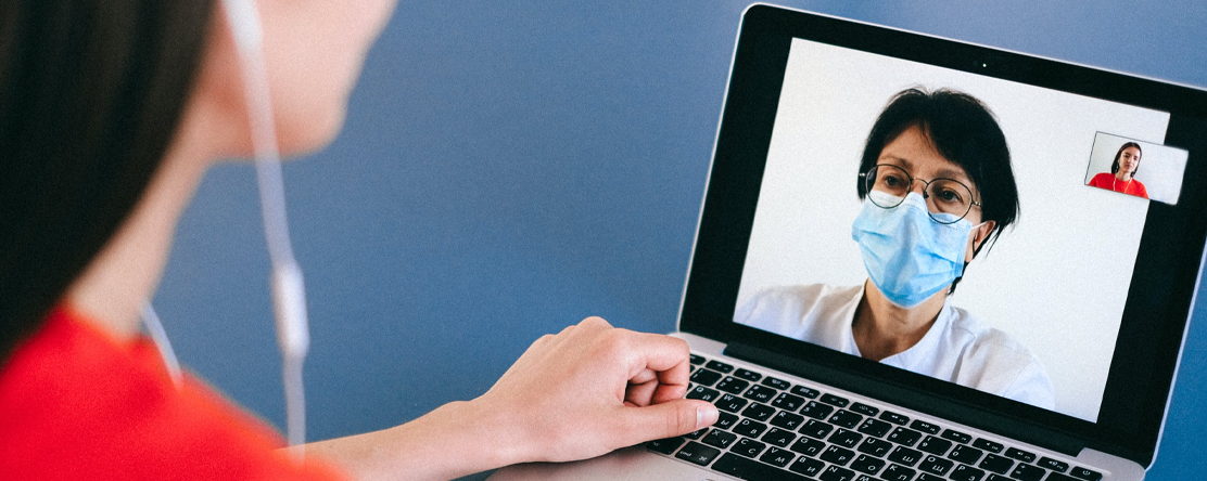 patient speaking to doctor on video call on laptop