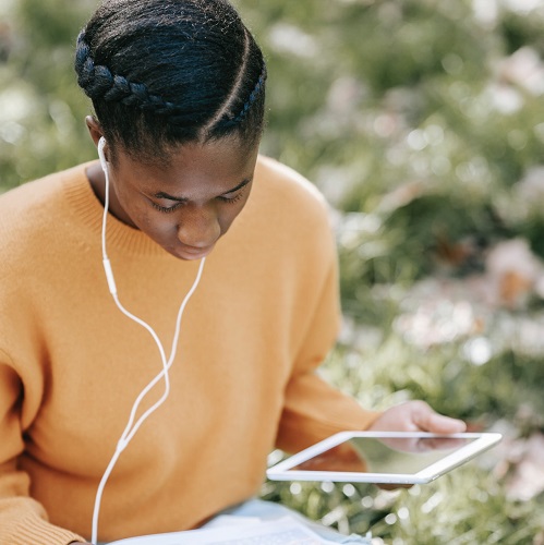 Black woman looking at study results on a tablet