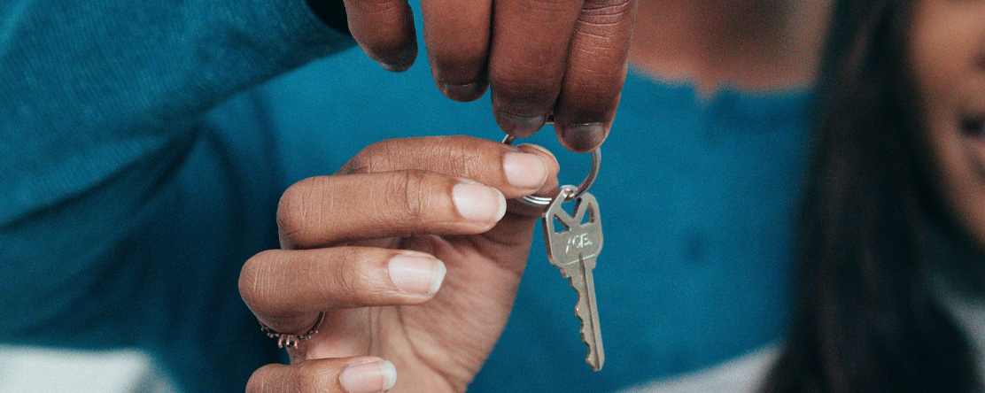 two people holding keys to new home
