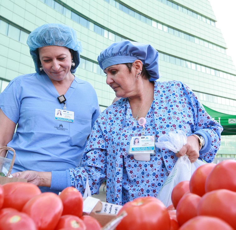 Two doctors visit a farmer's market outside a hospital