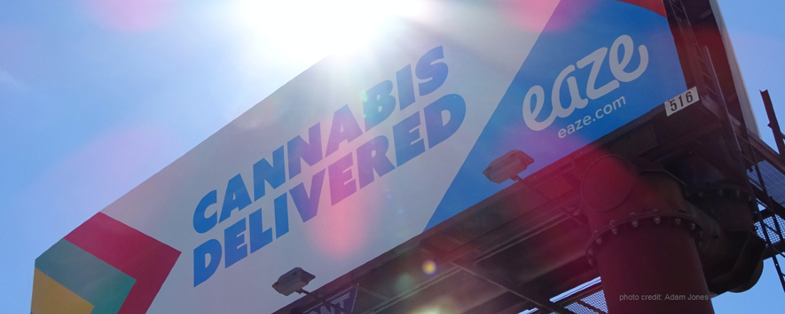 a colorful billboard reading "Cannabis Delivered" (credit: Adam Jones)