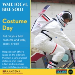 a poster for a costume day showing a man in an astronaut costume riding a bicycle