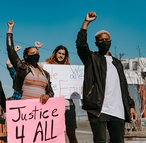 People at a protest holding signs in support of racial justice