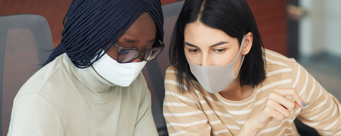 two women at work wearing mask