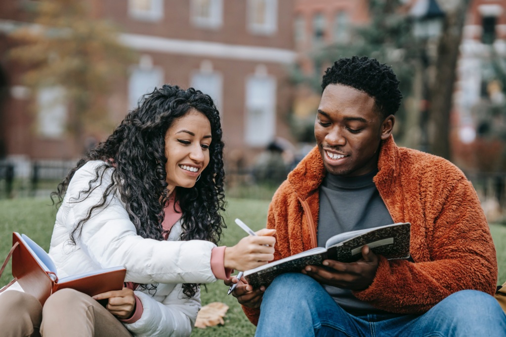 college students writing in notebook