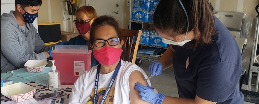 a woman getting a vaccine at a clinic