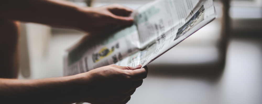 Person holding a newspaper