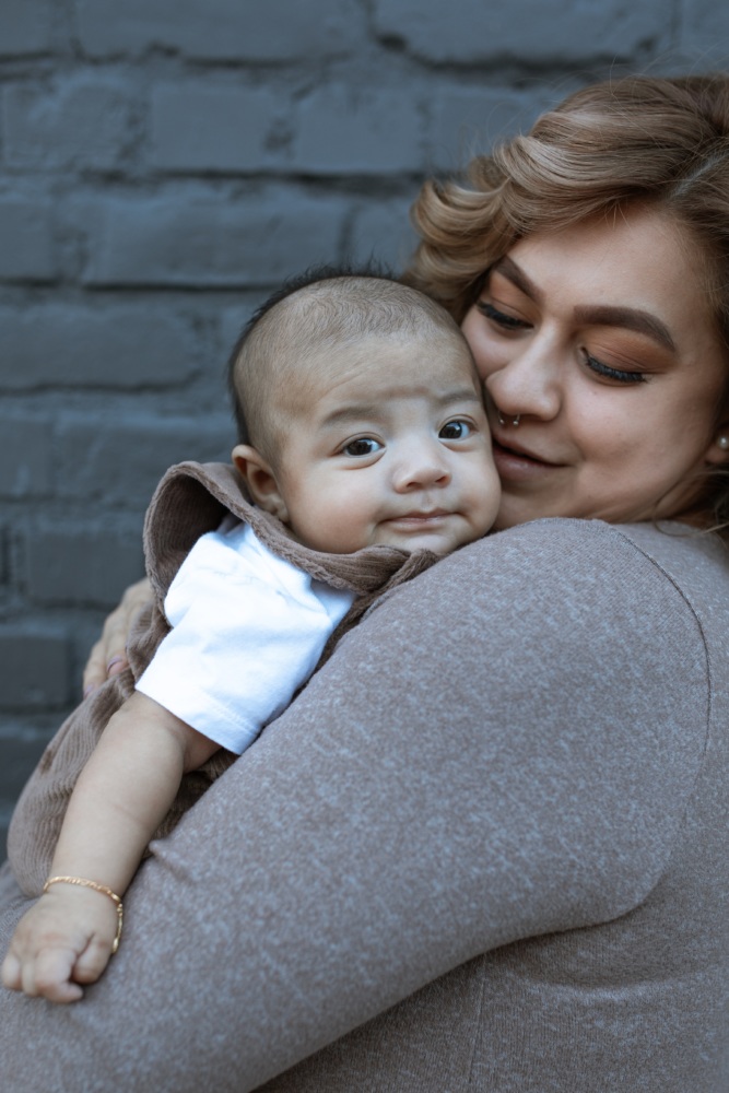 Latinx mom holding son