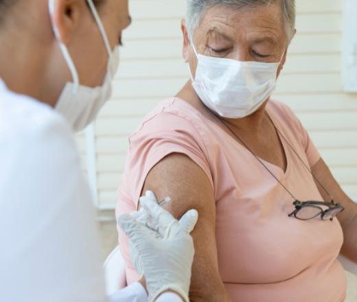 Older woman receives a vaccine