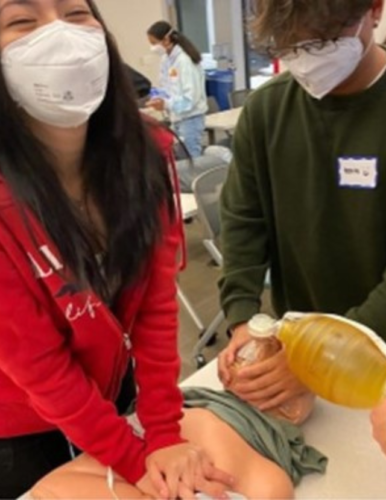 Youth practicing CPR from FACES Summer Youth Academy