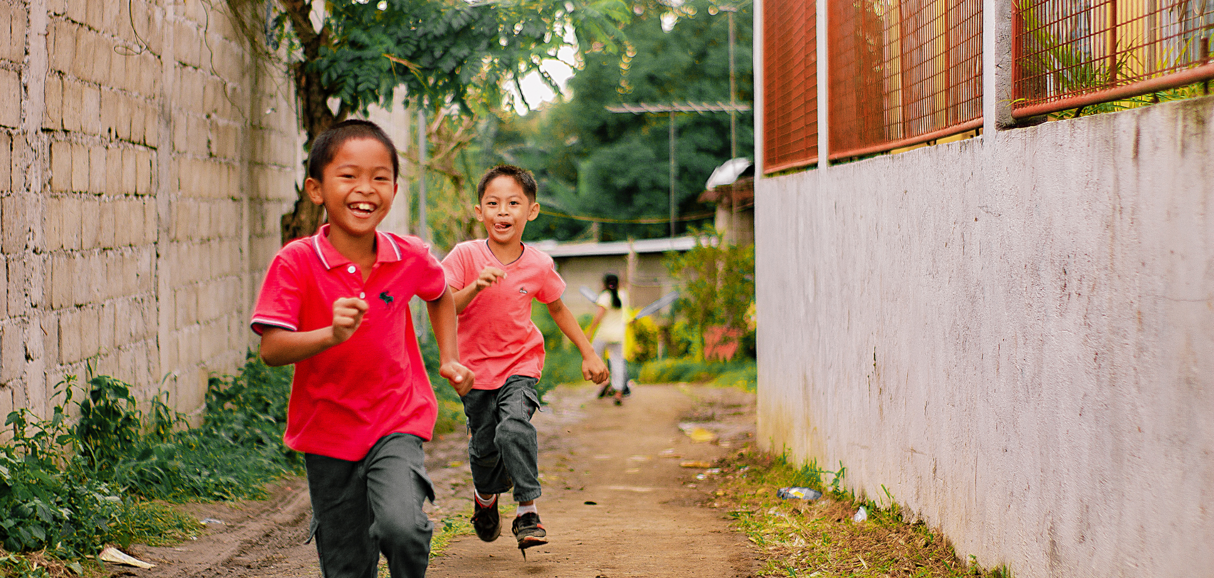Kids running down a path