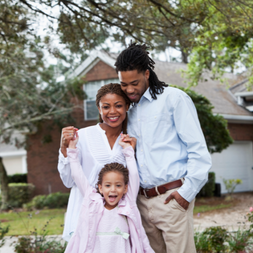 Family standing in front of a house