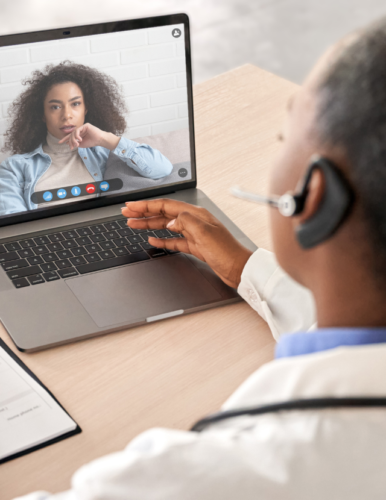 Doctor gives telehealth support via a computer