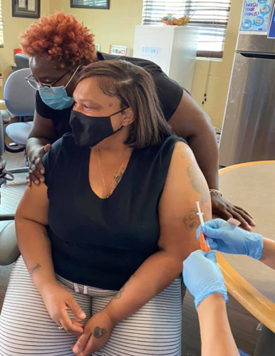 Woman getting COVID vaccine