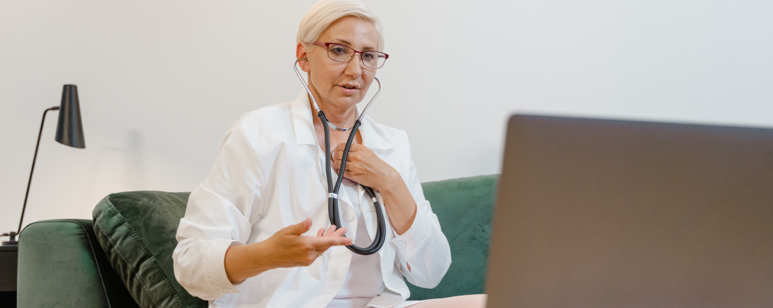 doctor in virtual meeting on laptop