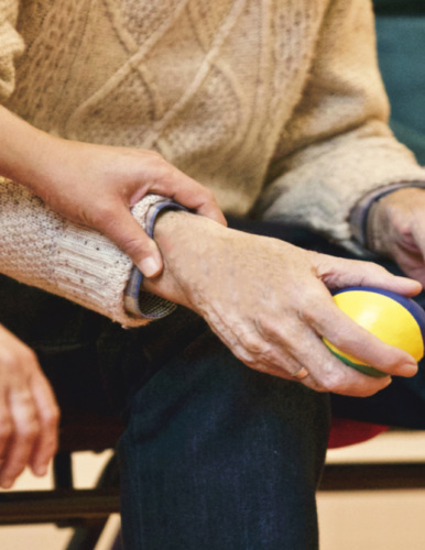 hand holding wrist of someone holding stress ball