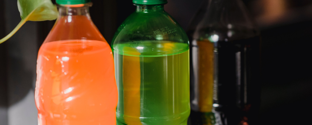 three plastic bottles of soda placed next to each other