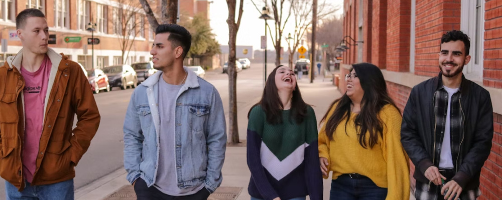 happy teens walking on street