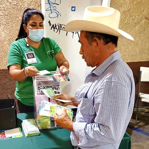 community health worker handing out flyer