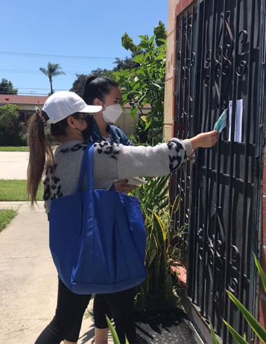 community health workers leaving flyer on door