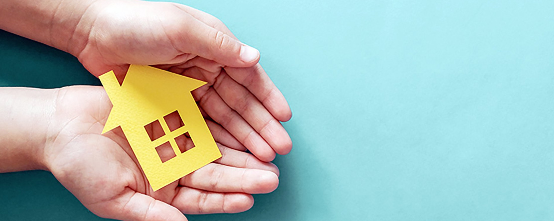 hands holding a paper house