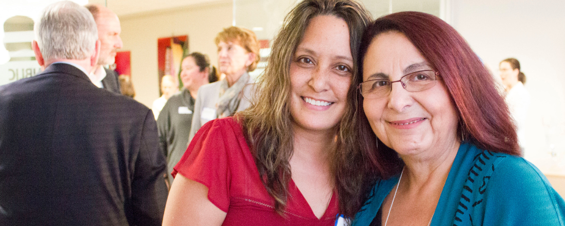 PHI staff Carmen and Stephanie, smiling to camera