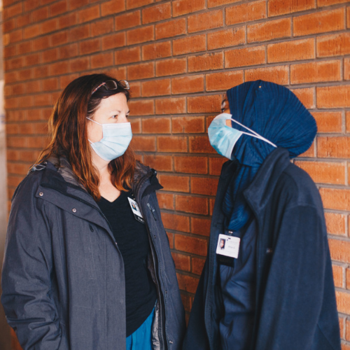 Two women talking at a well-being clinic