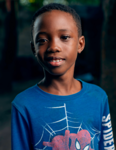 African American boy wearing a Spider Man shirt