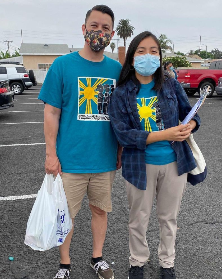 Two volunteers canvassing their neighborhood with COVID information and resources