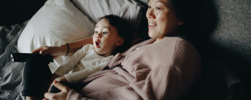 Pregnant mom laying next to young boy