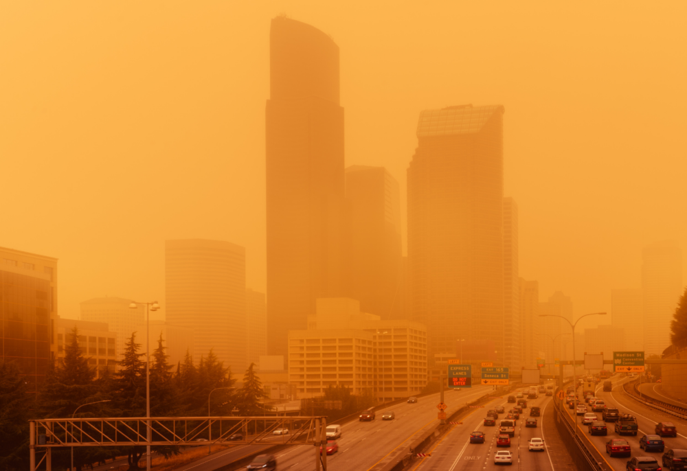 Seattle skyline and highway covered in orange wildfire smoke