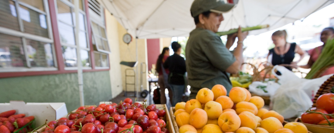 community members next to fresh produce