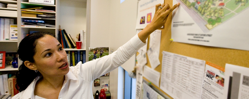 woman pointing at bulletin board