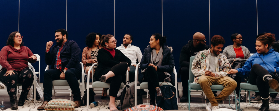 Group of people sitting in chairs (Unsplash)