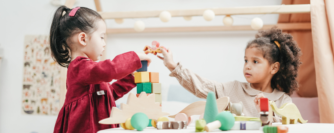 two girls playing with blocks at daycare