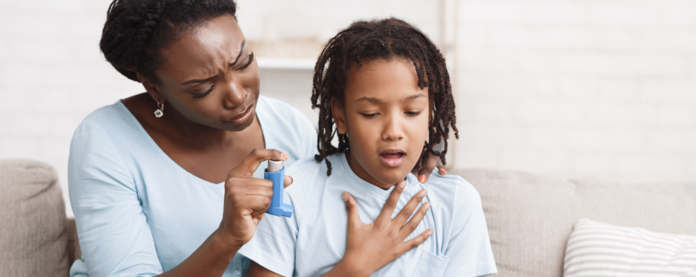 Mother holding an inhaler for her child who is struggling to breathe