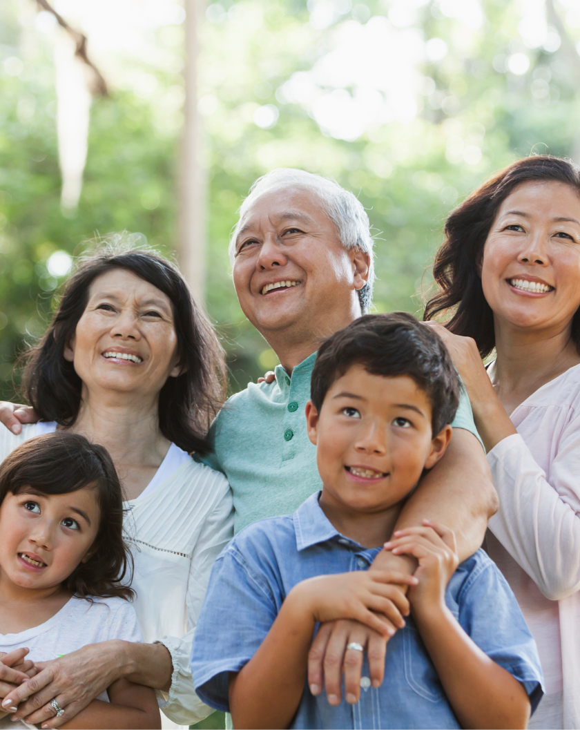 Asian family, standing together outside